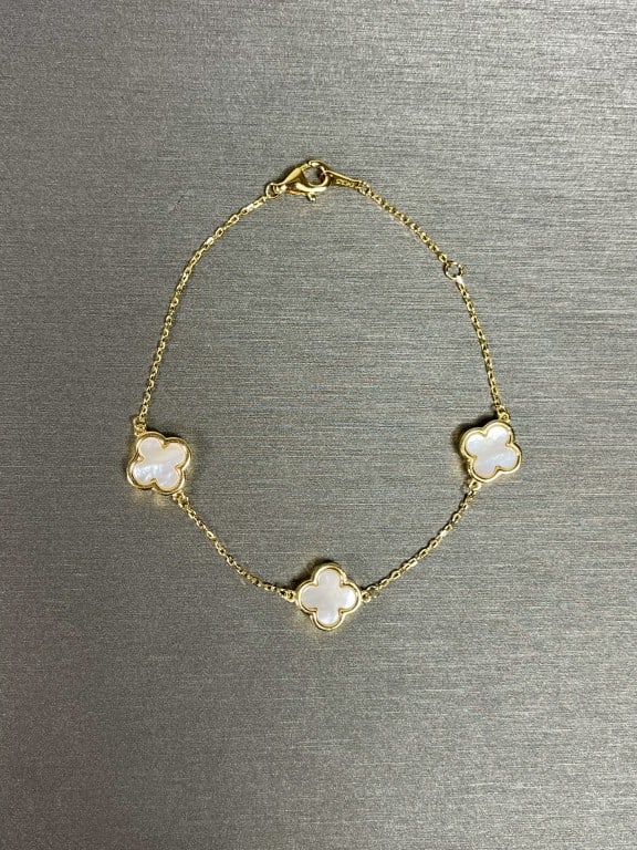 ELEGANT GOLD VERMEIL BRACELET: With three cloverleaf motifs of mother-of-pearl and zircon stones. Designed by Rachel Zoe.