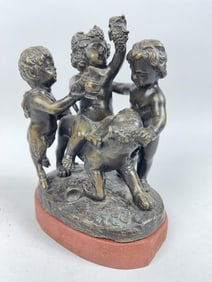 BRONZE FIGURAL GROUP OF PUTTI AND A CUB