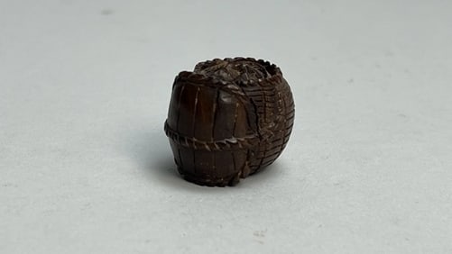 SMALL CARVED NETSUKE OF A BARREL