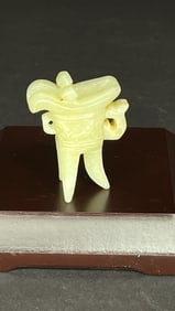 A MINIATURE JADEITE STONE OF A LIBATION CUP