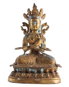 A GILT BRONZE FIGURE OF A TIBETAN BUDDHA