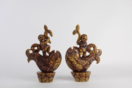 PAIR OF CARVED FIGURAL SOAPSTONES OF A MAN ON FISH