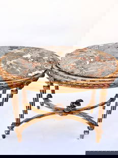 EUROPEAN OVAL GILTWOOD LOW TABLE WITH MARBLE TOP: Beautiful veining on marble top enframed in giltwood sides all around, and ribbed tapering legs joined by an x stretcher and a finial in the middle. H: 25 in. L: 34 in. W: 22 in.