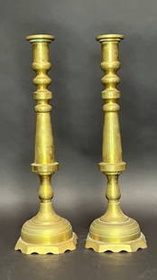 PAIR OF GILT BRONZE CANDLESTICKS: Of elegant, timeless style, showcases a classic silhouette with elegant curves and ridges.