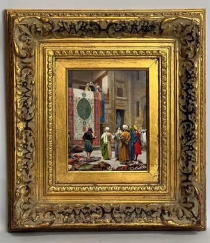 FRAMED FINE PLAQUE OF A CARPET MARKET: Vibrant depiction of carpet vendors and buyers in a souk. Set in a beautiful frame. Mark on verso.