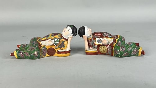 PAIR OF PORCELAIN RECLINING FIGURES