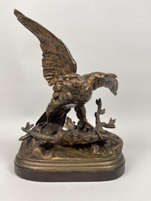 BRONZE FIGURAL GROUP OF A HUNTING EAGLE