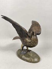 BRONZE FIGURAL GROUP OF AN EAGLE