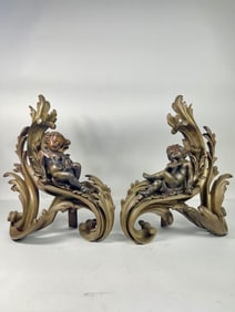 PAIR OF BRONZE FIREPLACE ANDIRONS WITH CHERUBS