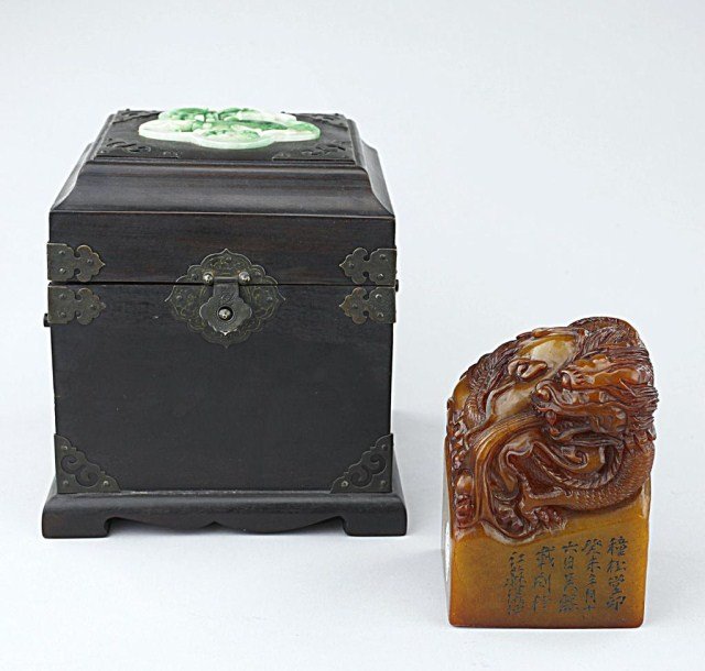 CHINESE CARVED SOAPSTONE SEAL WITH WOODEN BOX: The wooden box surmounted by a jadeite plaque. H: 4 3/4 in.