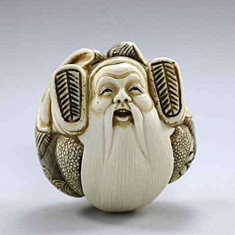 ANTIQUE JAPANESE CARVED IVORY NETSUKE: of an old man dressed in a robe and contorted as a ball. Signature to read, Koushin H: 1 5/8 in.