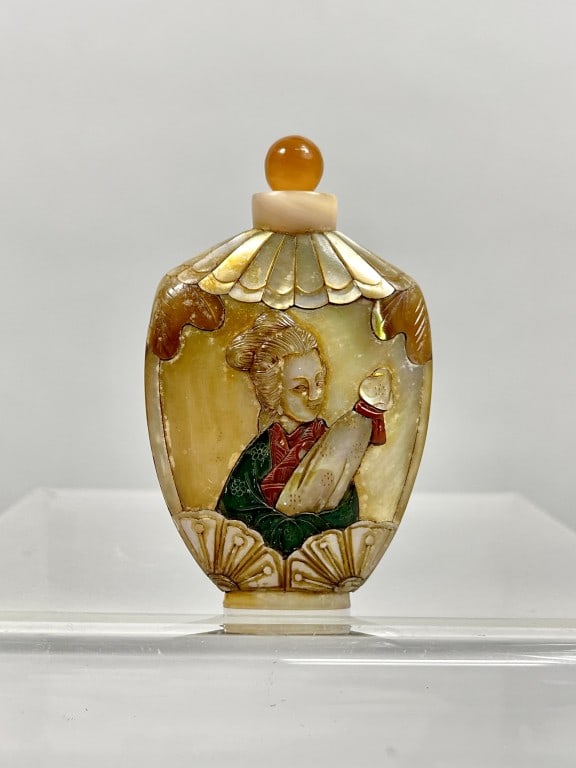 BEAUTIFUL CHINESE MOTHER-OF-PEARL SNUFF BOTTLE: Beautifully carved with two beauties on the body. Four-character mark on bottom to read Qianlong. H: 3 in. W: 1 3/4 in.