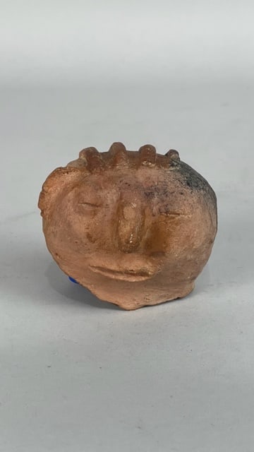 MOULDEDCLAY, OF A HUMAN FACE, NIAO-SUNG STYLE: If moulded in period, per Taiwannews.com, "it is believed to have been created between 1,300 and 1,800 years ago and is part of the Niao-Sung Culture, located in today?s Xinshi District. The work has 