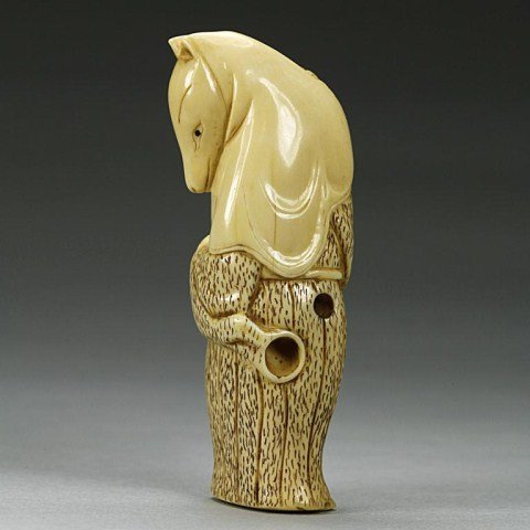 ANTIQUE JAPANESE CARVED NETSUKE: of a mythical animal. H: 2 3/4 in.
