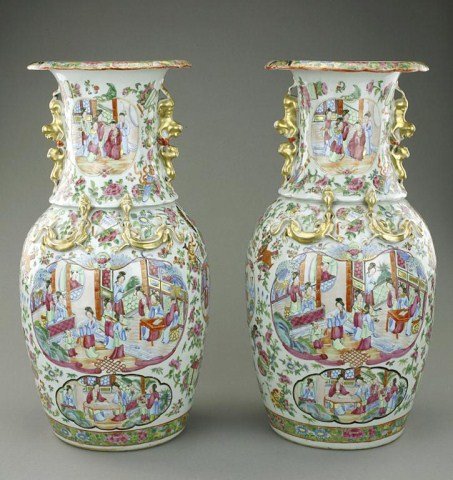 PAIR OF ANTIQUE CHINESE CANTON VASES, 19TH CENTURY: Each of baluster form, with two Buddhist lion handles and kui dragons applied to the shoulder, decorated with panels enclosing figures in a palace setting, surrounded by flowers, insects, and further 