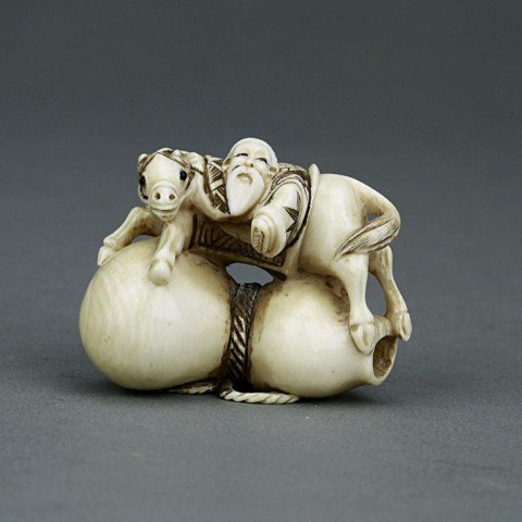 ANTIQUE CHINESE CARVED IVORY NETSUKE: From the Private collection of Mr. Paul Siegal. Figure of an elder on top of a double gourd jug. H: 1 1/4 in.(3cm)