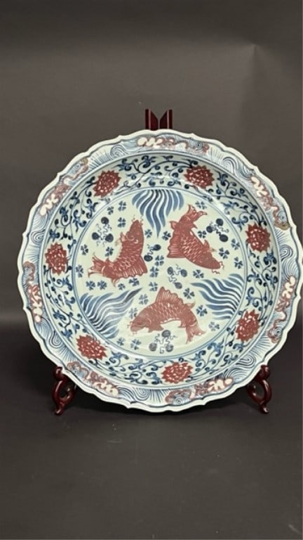 CHINESE BLUE AND IRON RED PLATE: Bearing thee gold fish centrally, and bats around the side, among tendrils and blooms. H: 2 1/2 in. D : 17 7/8 in.