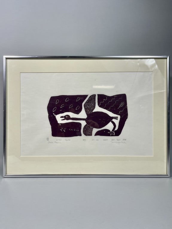 JOSIE PAMIUTU PAPIALUK (PAPERK), INUIT (1918-1996): Framed, titled "Singing Bird / Un oiseau chante." A black and white stonecut on paper that depicts a bird flying in the rain. Pencil signed and numbered 33/40 on the bottom. Josie Pamiutu Papialuk,