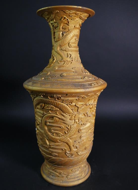 A CHINESE GOLDEN POWDER GLAZED VASE: Moulded in high relief of dragons chasing pearl above sea waves throughout the body all the way to its trumpet neck. H: 23 in.
