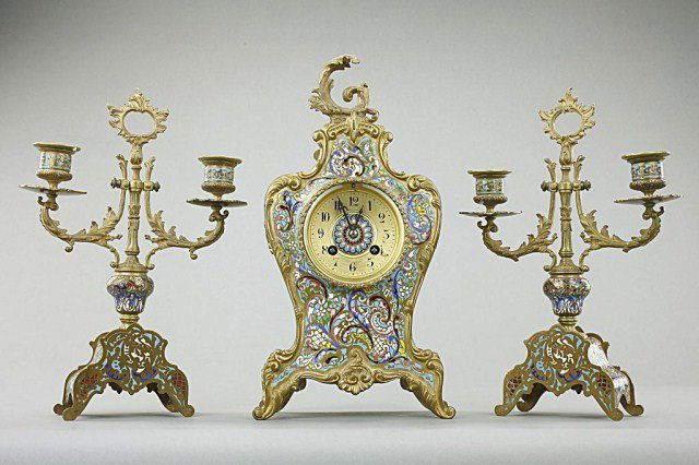 FRENCH THREE PIECE CLOISONNÉ ENAMEL CLOCKSET: This is a garniture set of mantel clock and pair of candelabras decorated wit exquisite cloisonné enamel. H: 13 1/4 in.