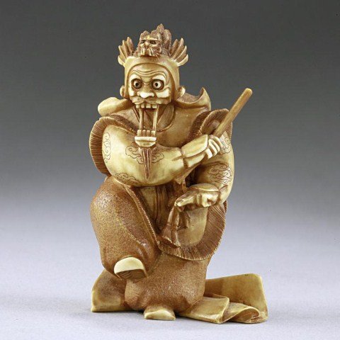 ANTIQUE JAPANESE IVORY OKIMONO OF A SAMURAI: From the Private Collection of Harry Lawrence of Laguna Beach. Warrior in a full dress and mask. H: 2 3/8 in.(6cm)