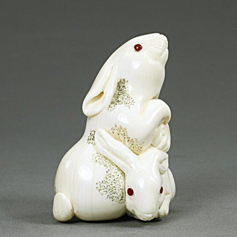 ANTIQUE JAPANESE IVORY NETSUKE FIGURE: of two albino rabbits. H: 1 3/4 in.