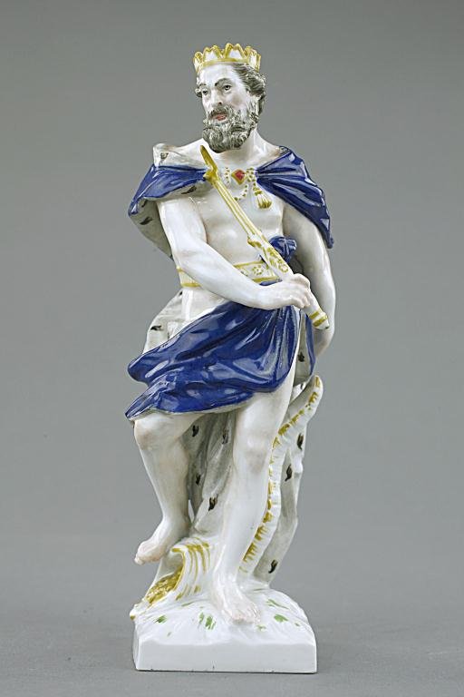 PORCELAIN FIGURE OF AN OLD MAN: With beard, wears a crown, a cobalt blue cape and holds a sword .Stamp on the base, KPM. H: 6 3/8 in.