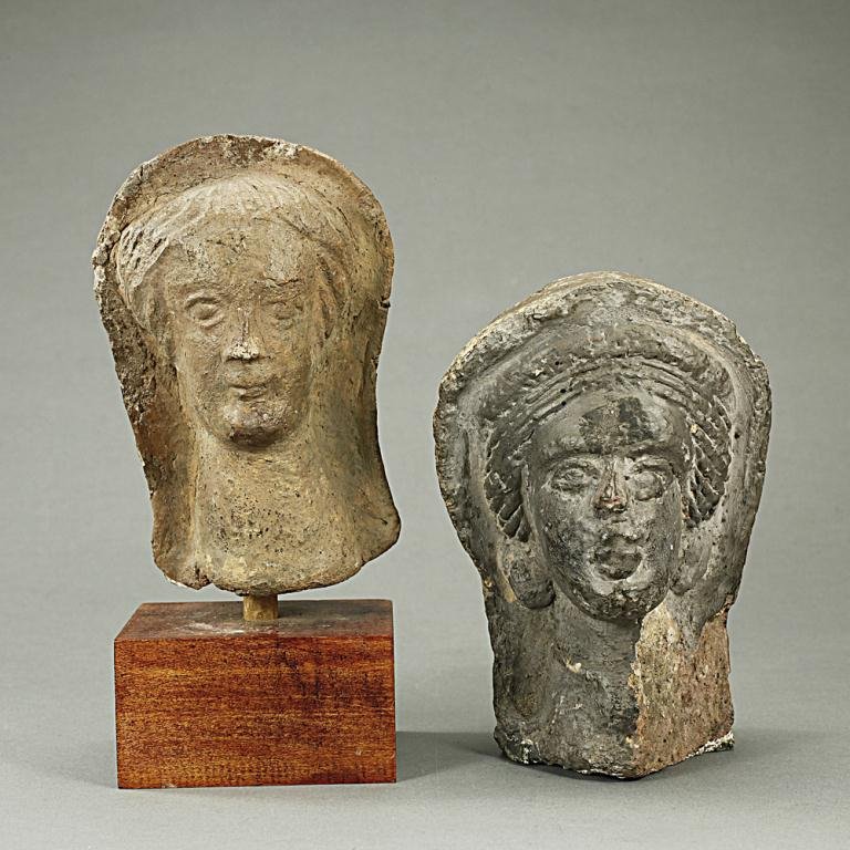 TWO TERRACOTTA BUSTS: From the British School of Archaeology in Egypt. Featuring two heads in high relief. H: 5 1/2 in.