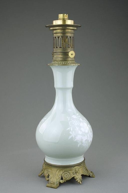CHINESE CELADON BOTTLE VASE, SET AS A LAMP: 18th Century. Mounted on ormolu, the well potted globular body issues a slender flaring neck, lightly separated by a flange. H: 9 in.(23cm)