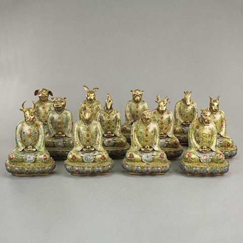 SET OF 12 CHINESE CLOISONNÉ FIGURES OF ZODIAC SIGNS: With finely cast gilt animal heads, human body wearing cloisonné robes and seated on lotus pedestals in the posture of Buddhist figures. H: 10 3/4 in.