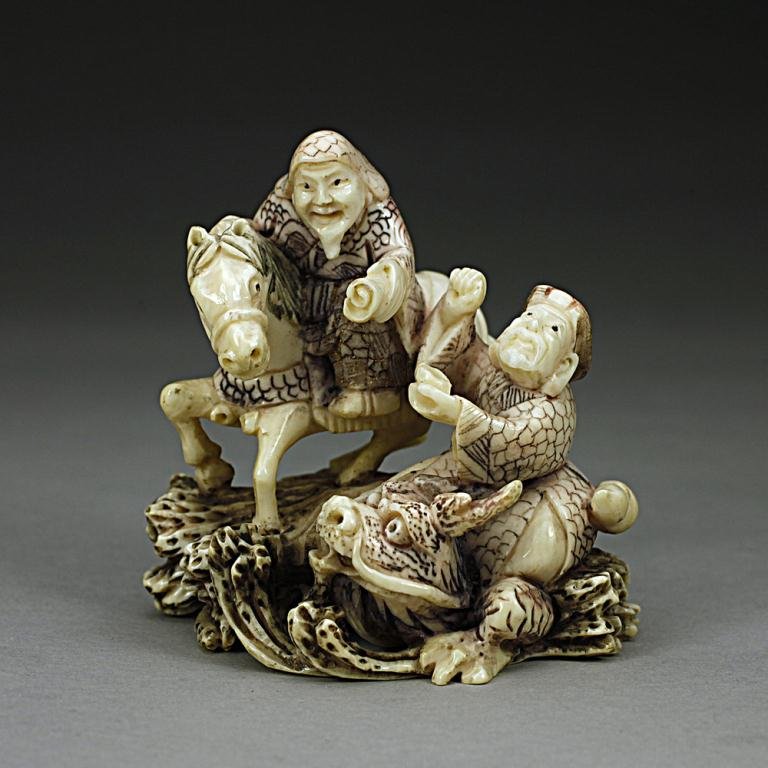 ANTIQUE JAPANESE CARVED IVORY NETSUKE: From the Private collection of Mr. Paul Siegal. Figure of two men, one riding a horse, the other riding a dragon. H: 2 1/8 in.(5.5cm)