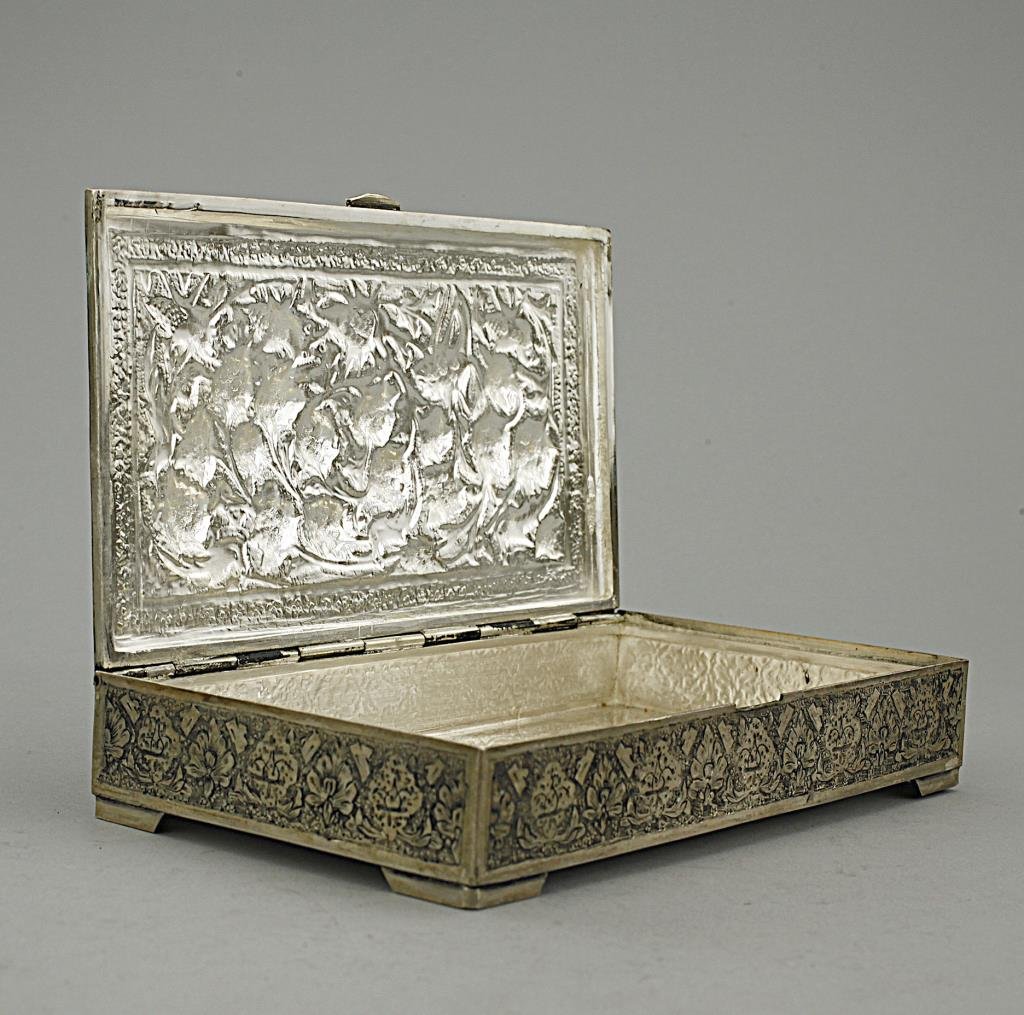 OLD PERSIAN SILVER BOX: With carving of flowers and birds in relief on the cover. Total weight of 550g. L: 7 1/8 in. x W: 4 in.