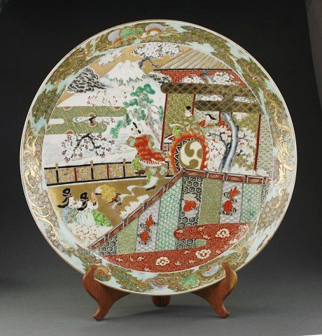 VERY LARGE ANTIQUE JAPANESE IMARI CHARGER: With hand painted scenes of four different panels of textiles and figural family gathering scenes. Dragons painted on the rim with geometric designs. D: 24 3/8 in.