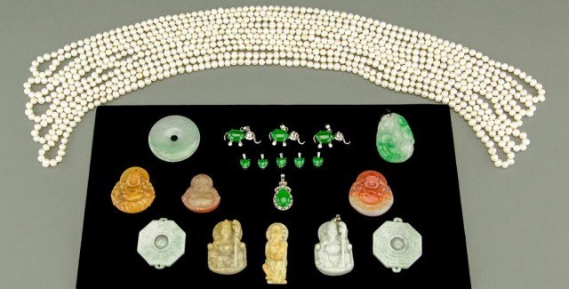 GROUP OF ASSORTED ITEMS: Comprising of ten Chinese carved stone pendants: one light green jade disc with a hole in the center, one white and red soapstone happy Buddha, one yellow soapstone happy Buddha, one white jade seated
