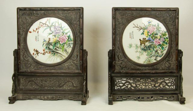 PAIR OF CHINESE CARVED WOOD TABLE SCREENS: With circular porcelain plaques hand painted over the glaze with a different pair of brown birds on each plaque and multicolor peonies. Square wood screen carved with scrolling flower designs in relie