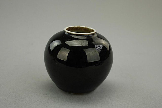 SMALL CHINESE BLACK BACKGROUND MINIATURE JAR: Ovoid form; of a sleek ebony color. H: 2 3/4 In.
