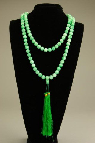 CHINESE GREEN JADEITE BEADED NECKLACE: With 108 court beads and two green tassels. L: 25 1/2 in.