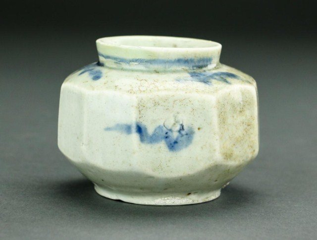 ANTIQUE KOREAN BLUE & WHITE FACETED GLOBULAR JAR: Faint blue hue to the white ground; blue splashes under the glaze around the body, shoulder, and line around the neck. H: 2 7/8 in.