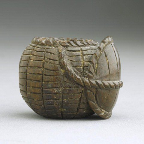ANTIQUE JAPANESE WOOD NETSUKE OF FISH IN A BASKET: From a Private Collector in Florida. A turtle shell tied with rope to the side of the basket. H: 1 1/8 in.