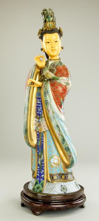 ANTIQUE CHINESE CLOISONNE FIGURE OF GUANYIN: In standing position, with a small bird perched on her left forearm. Wears an elegant multi pattern robe in tones of white, pink, red, turquoise and royal blue; featuring some gilt detail. Hair is in