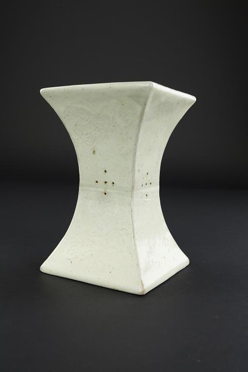 ANTIQUE CHINESE WHITE PORCELAIN PILLOW: ANTIQUE CHINESE WHITE PORCELAIN PILLOW Song dynasty. Decorated allover with gently incised floral blooms. With pierced diamond design to sides. From the Marlin collection of Beverly Hills, CA. H: 7 5/