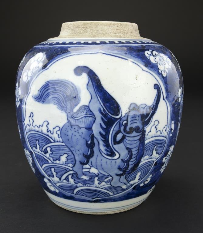 CHINESE KANGXI STYLE BLUE AND WHITE JAR: 19th century. The body with round lobed panels depicting foo dogs. Double ring mark to the bottom. H: 7 in.