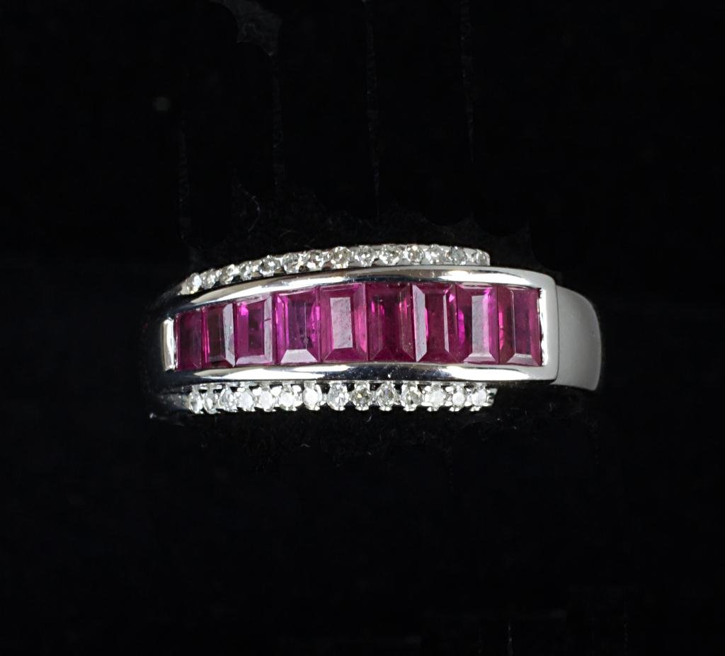 RUBY AND DIAMOND LADY'S RING: Ruby baguette three row channel set ring with diamonds lining top and bottom of ruby. Set in 14 carat white gold.
