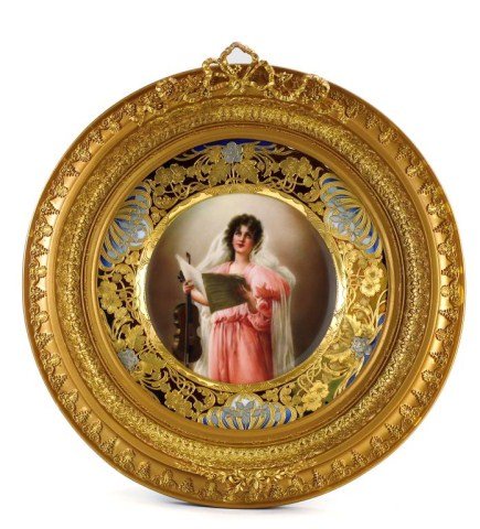 MAGNIFICENT VIENNA PORCELAIN PLAQUE: Depicting a beautiful woman gazing up, wearing a pink dress and flowing white veil. Holding a song book and violin. In an ornately decorated round gilded frame. D: 14 1/8 in.