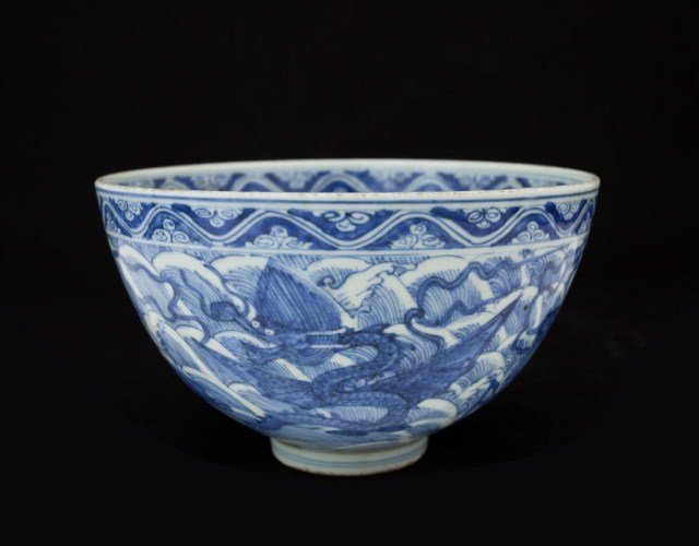 CHINESE BLUE & WHITE DRAGON BOWL: Body with dragons surrounded a horse with clouds in the background. Geometric swirls band around the bowl rim interior and exterior. The center roundel contains a dragon. Mark to bottom. H: 3 7/8 in.