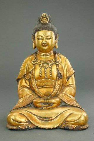 CHINESE GILT BRONZE FIGURE OF SEATED GUANYIN: Wearing a long draped robe, she sits with legs crossed and hands in the meditation mudra. Her hair in a top know secured by a hair pin with a miniature Buddha. Mark to the back. H: 14 7/8 in.