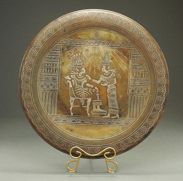 DAMASCUS METAL PLATE WITH INLAID SILVER DESIGN: Depicting an ancient Egyptian pharaoh and woman in the center roundel, and geometric design around the rim. D: 20 1/8 in.