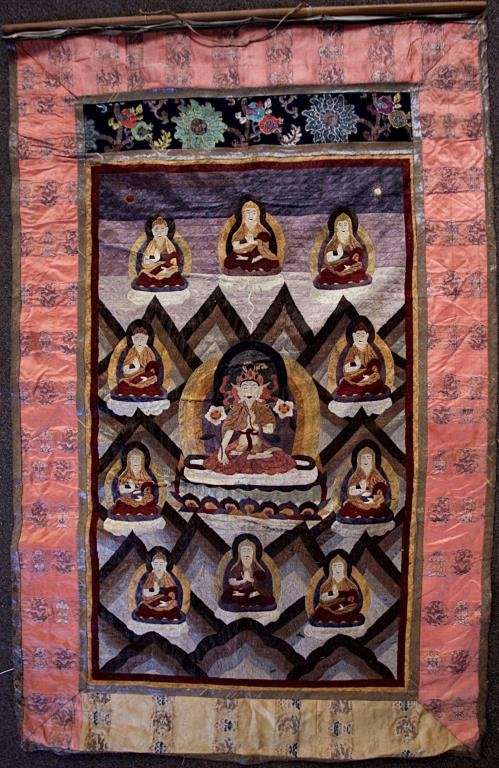 ANTIQUE 19TH C TIBETAN EMBROIDERED SILK THANGKA: Beautifully woven with multicolored threads and depicts a Buddha centers on a lotus throne, surrounded by ten smaller deities. H: 42 in ., L: 23 1/4 in.