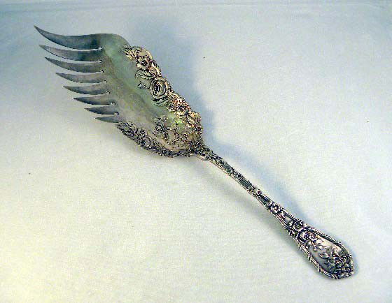 A STERLING SILVER FISH SERVER with allover floral d: A STERLING SILVER FISH SERVER with allover floral design 9 ½"; approx 65.7 dwt.