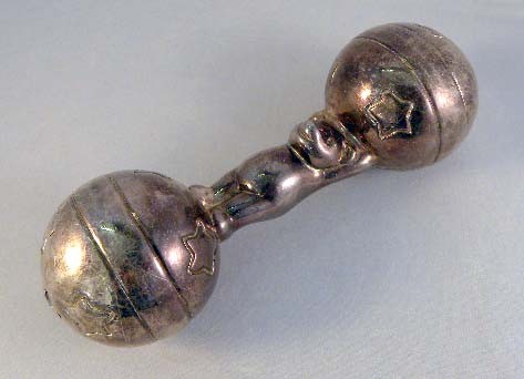 A TIFFANY & CO. STERLING SILVER BABY RATTLE with te: A TIFFANY & CO. STERLING SILVER BABY RATTLE with teddy bear central figure 5 ½"; approx 54 dwt.